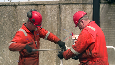 Contractors adjusting equipment